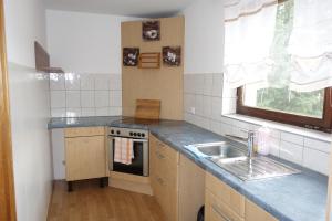 a small kitchen with a sink and a stove at Wirtshaus zum Stern in Satteins