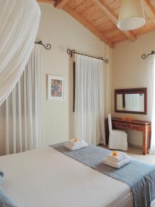 a bedroom with a bed with two towels on it at Mastrogiannis Villa Levanda in Kavvadádes