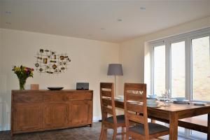 comedor con mesa de madera y sillas en The Old Bottle Store - 2 Double Bedrooms, 2 Bathrooms, St Ives, Cambridgeshire, en St Ives