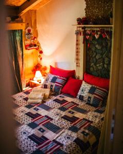 a bedroom with a bed with a quilt on it at Ladybird Lodge in Bela Crkva