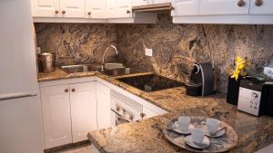 a kitchen with a counter with cups and saucers on it at Ocean Studio Maspalomas in San Agustin