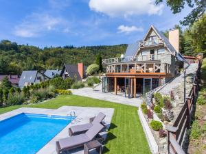 an estate with a swimming pool and a house at Dom Beskidy in Brenna