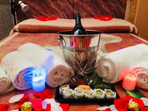 a table with towels and a candle and sushi at Casa Vacanze In Love in Marina di Montemarciano