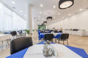 クリニツァ・ズドルイにあるApartamenty w Williの青と白のテーブルと椅子が備わる宴会場