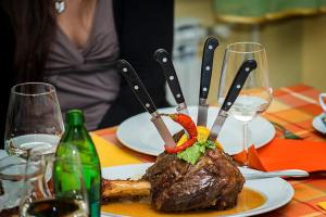 a plate of food with knives on top of it at Gostilna Tratnik in Zoll