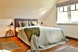 a bedroom with a bed and a window at Holmi Maja in Haapsalu