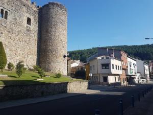 a building with two towers next to a street at Casa Aquelcabos in Arenas de San Pedro