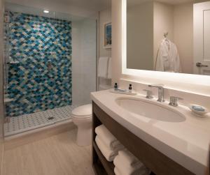 a bathroom with a sink, toilet and bathtub at The Laureate Key West in Key West
