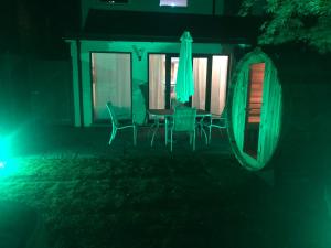a house with a table and chairs in the dark at Bournemouth Hot Tub & Sauna Holiday Let in Bournemouth