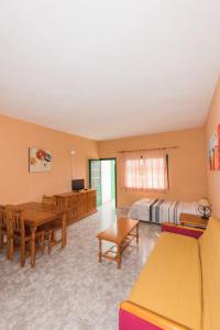 a large room with a bed and a table at Apartamentos Las Casitas in Frontera