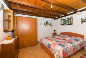 a bedroom with a bed and a wooden ceiling at House Svjetlana in Postira