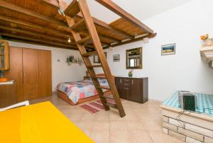 a bedroom with a bunk bed and a ladder at House Svjetlana in Postira