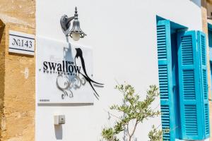 a sign on the side of a building at Cypriot Swallow Boutique Hotel in North Nicosia