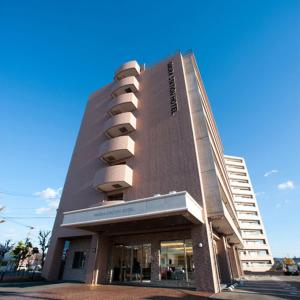 a building with balconies on the side of it at Omura Station Hotel in Omura