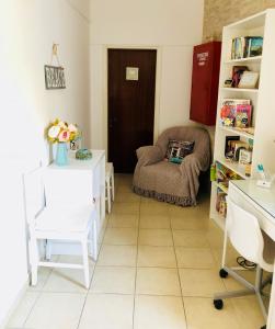 a living room with a chair and a table at Hotel George in Agios Kirykos +51 photos