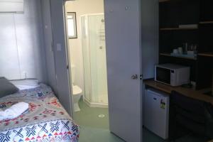 a small bedroom with a bed and a bathroom at Coonawarra Ensuite Unit C in Coonawarra