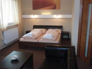 Säng eller sängar i ett rum på Hotel Galileo
