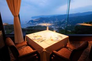 a table in a room with a view of a mountain at Hotel Grand Bach Atami Crescendo in Atami