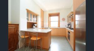 a kitchen with a counter and two stools in it at D2 at Watervale in Watervale