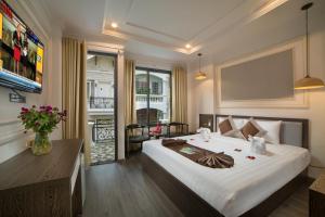 Ένα ή περισσότερα κρεβάτια σε δωμάτιο στο Galliot Central Hotel