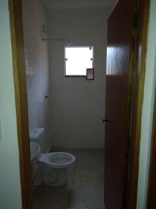 a bathroom with a toilet and a window at Casa de praia litoral norte SP in Caraguatatuba