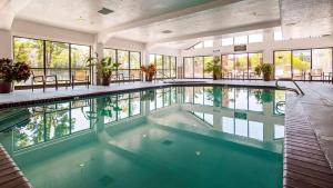 uma grande piscina interior num edifício com janelas em Best Western Plus Cotton Tree Inn em Sandy