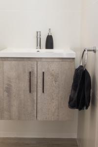 a bathroom with a sink and a white counter at Mudgee Apartments on Horatio Street in Mudgee