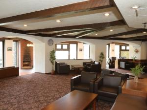 a waiting room with couches and chairs and tables at Shirakabako View Hotel in Tateshina