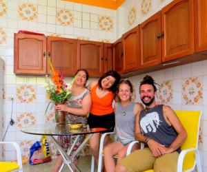 a group of people sitting around a table in a kitchen at Santa Victoria House in Chiclayo
