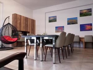 a dining room with a black table and chairs at Hsu One One B&B in Magong