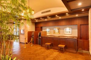 a barbershop with a waiting room with benches and plants at Hotel Mori no Kaze Nasu in Nasu