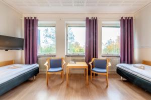 Postel nebo postele na pokoji v ubytování Västerbacken Hotell & Konferens