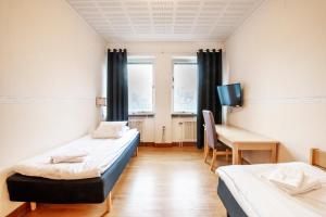 Postel nebo postele na pokoji v ubytování Västerbacken Hotell & Konferens