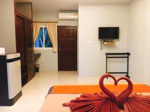 a room with a heart decoration on a bed at Bussarin Mansion Koh Yao Yai in Ko Yao Yai