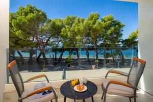 a patio with a table and chairs and a view of the beach at Hotel Central Beach 9 in Makarska