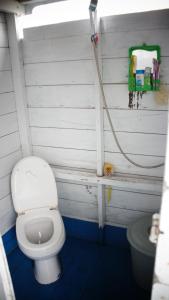 a bathroom with a white toilet in a room at Kelotok Orangutan Tanjung Puting in Kumai