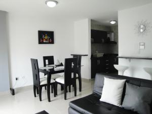a living room with a table and chairs and a couch at Santa Isabel Centro 401 in Santa Rosa de Cabal