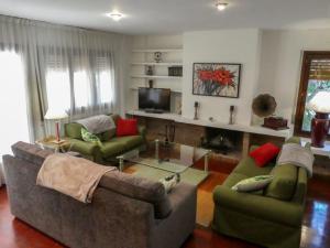 a living room with two couches and a television at EL ALJEZAR in Teruel