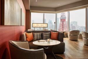 a living room with a couch and a table at The Prince Park Tower Tokyo - Preferred Hotels & Resorts, LVX Collection in Tokyo