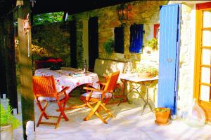 a patio with a table and two chairs and a table and a table and chairs at GITE LA FREYDIERE in La Bégude-de-Mazenc