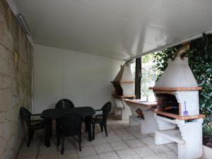 a patio with a table and a pizza oven at Casa da Mineira T2 in Geres
