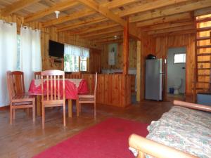 a dining room and kitchen with a table and chairs at Cabanas de Monasterio in Puerto Clocker