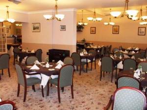a dining room with tables and chairs in a restaurant at Lauriston Hotel in Weston-super-Mare