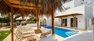 a villa with a swimming pool and a house at Thalassines Villas in Ayia Napa