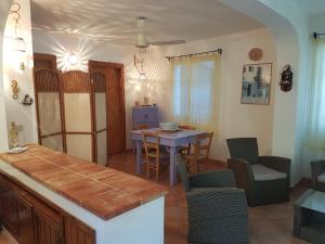 a kitchen and dining room with a table and chairs at Villetta Marausa - Birgi KITE in Marausa