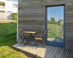 a table and two chairs on a wooden deck at La Huche in Namur