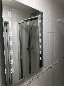 um espelho na casa de banho com um chuveiro em Old Hunters Lodge em Whipsnade