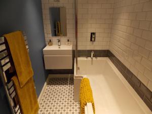 a bathroom with a tub and a sink at Fryers Cottage in Richmond +9 photos