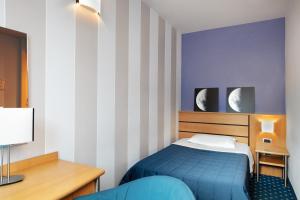 Postel nebo postele na pokoji v ubytování Garda Hotel