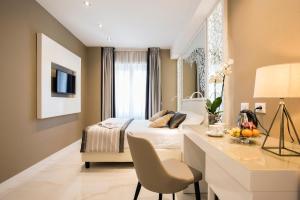 a hotel room with a bed and a desk and a room at Residenza Venti Settembre in Rome